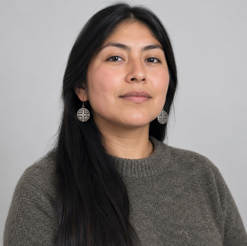 Studio portrait of a Mapuche woman in her 30s with long dark hair